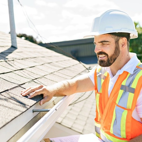 worker providing a roof inspection