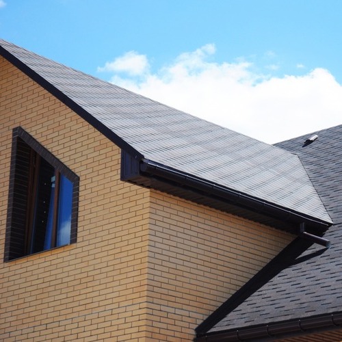 brick home with a shingle roof