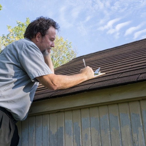 insurance adjuster inspecting a roof