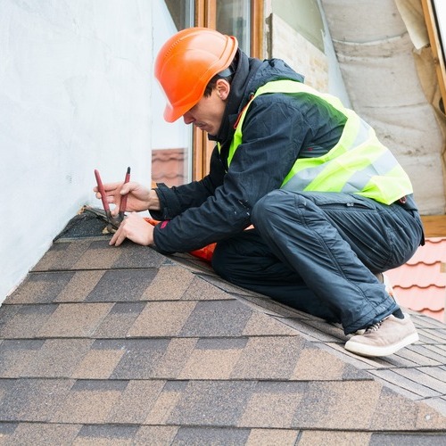 worker providing shingle repair