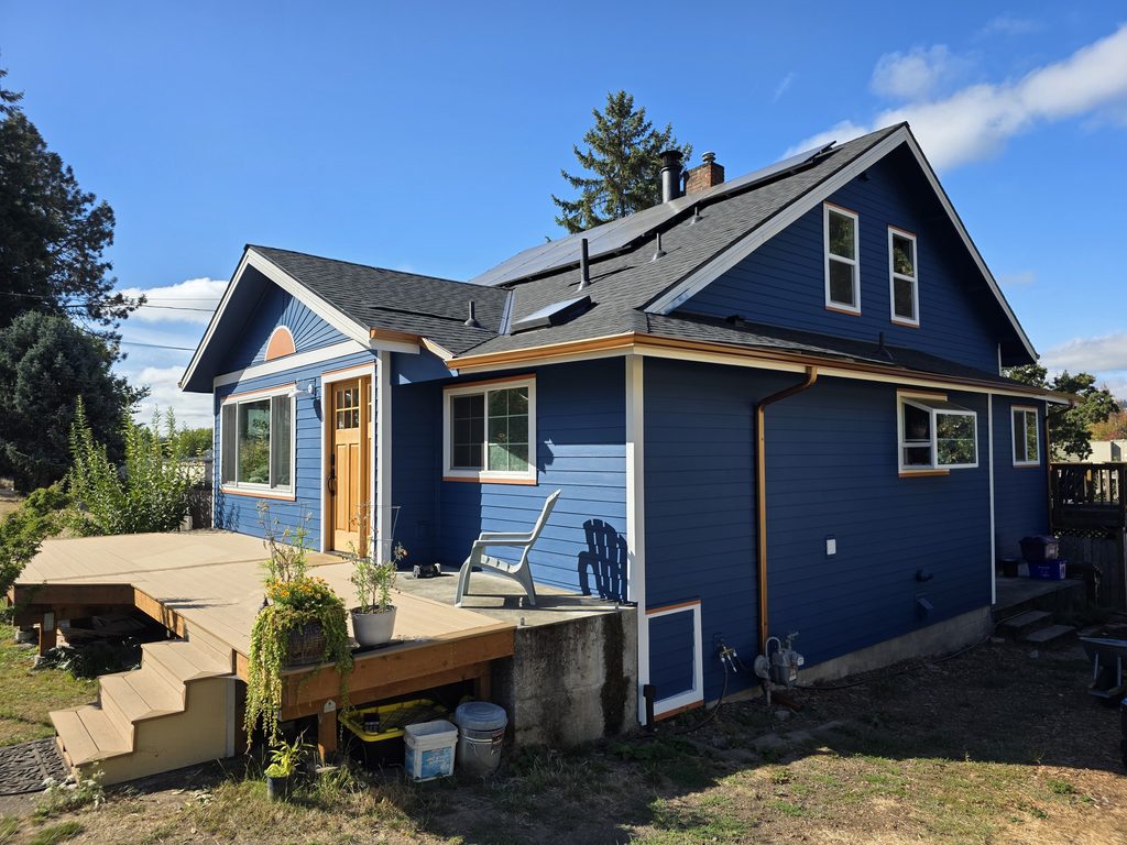 This is the front corner of the house with new siding, paint, and gutters.
