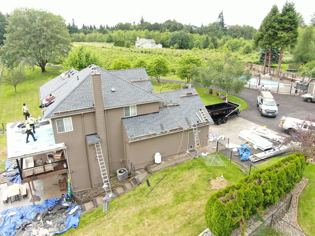 Side of house reveals roof nearly complete