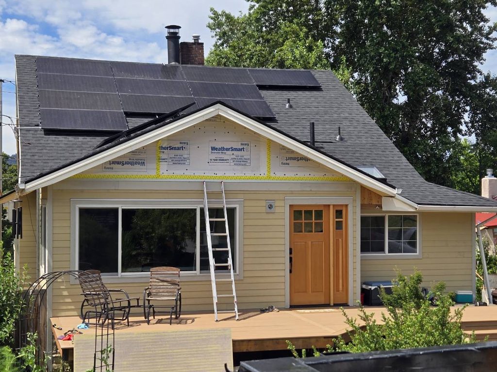 Front of house has the siding being installed.