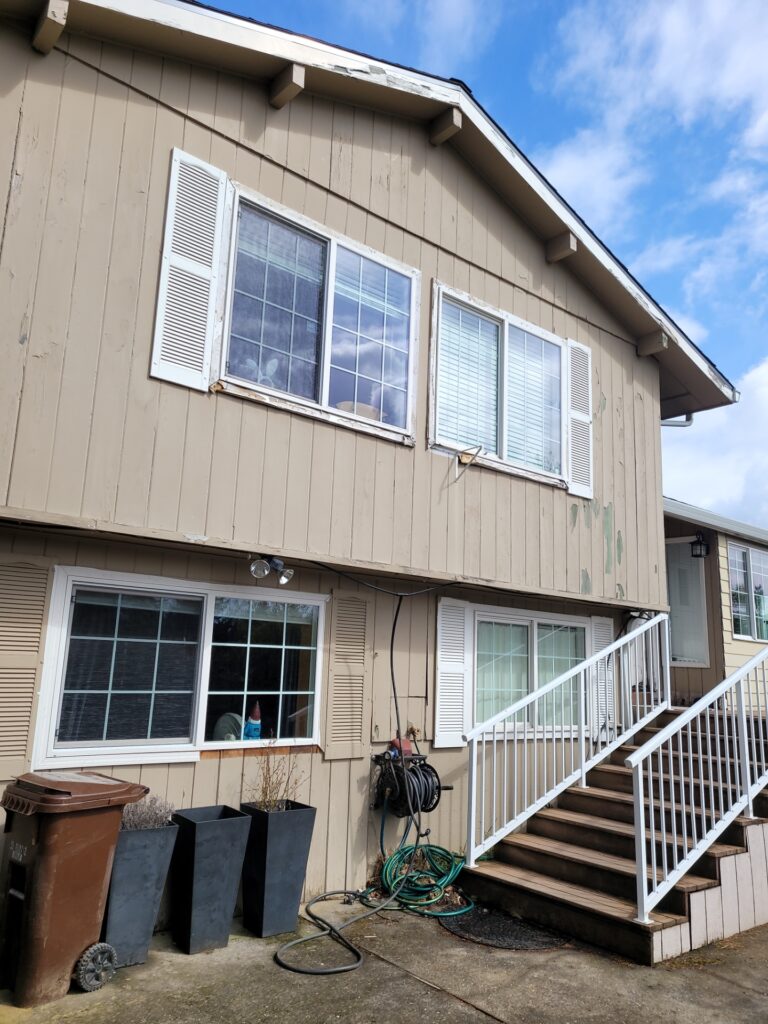 The front of the house has missing siding, trim and clear signs of rot