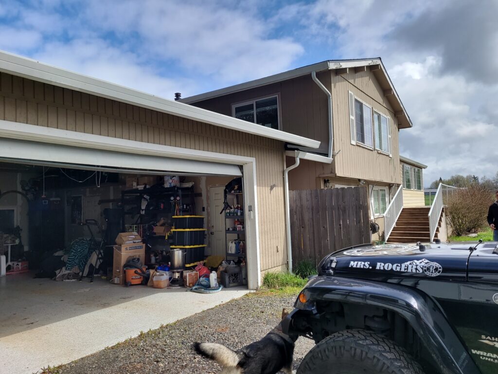 A wide angle shot of the Rodgers home looking from the garage side