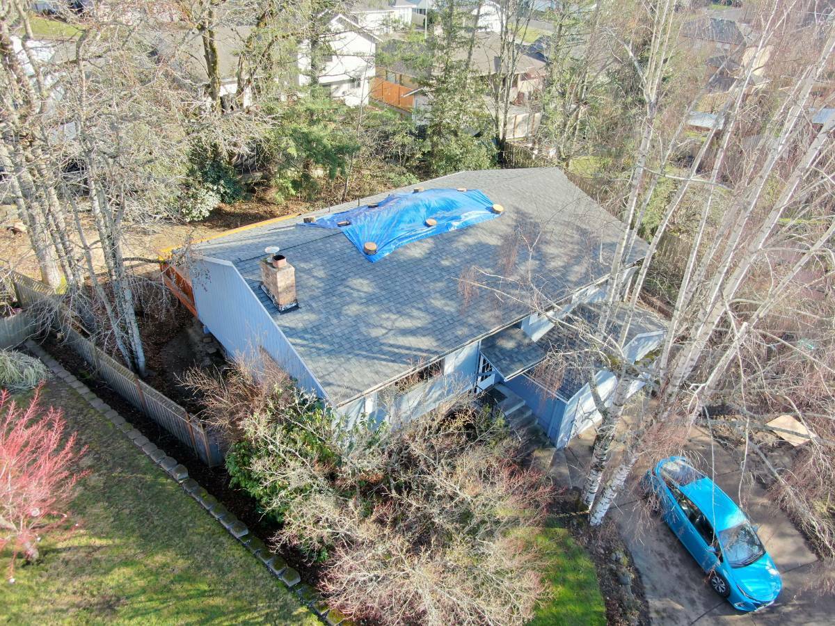 Aerial view of the temporary blue tarp protecting the damaged Gresham roof before structural repairs