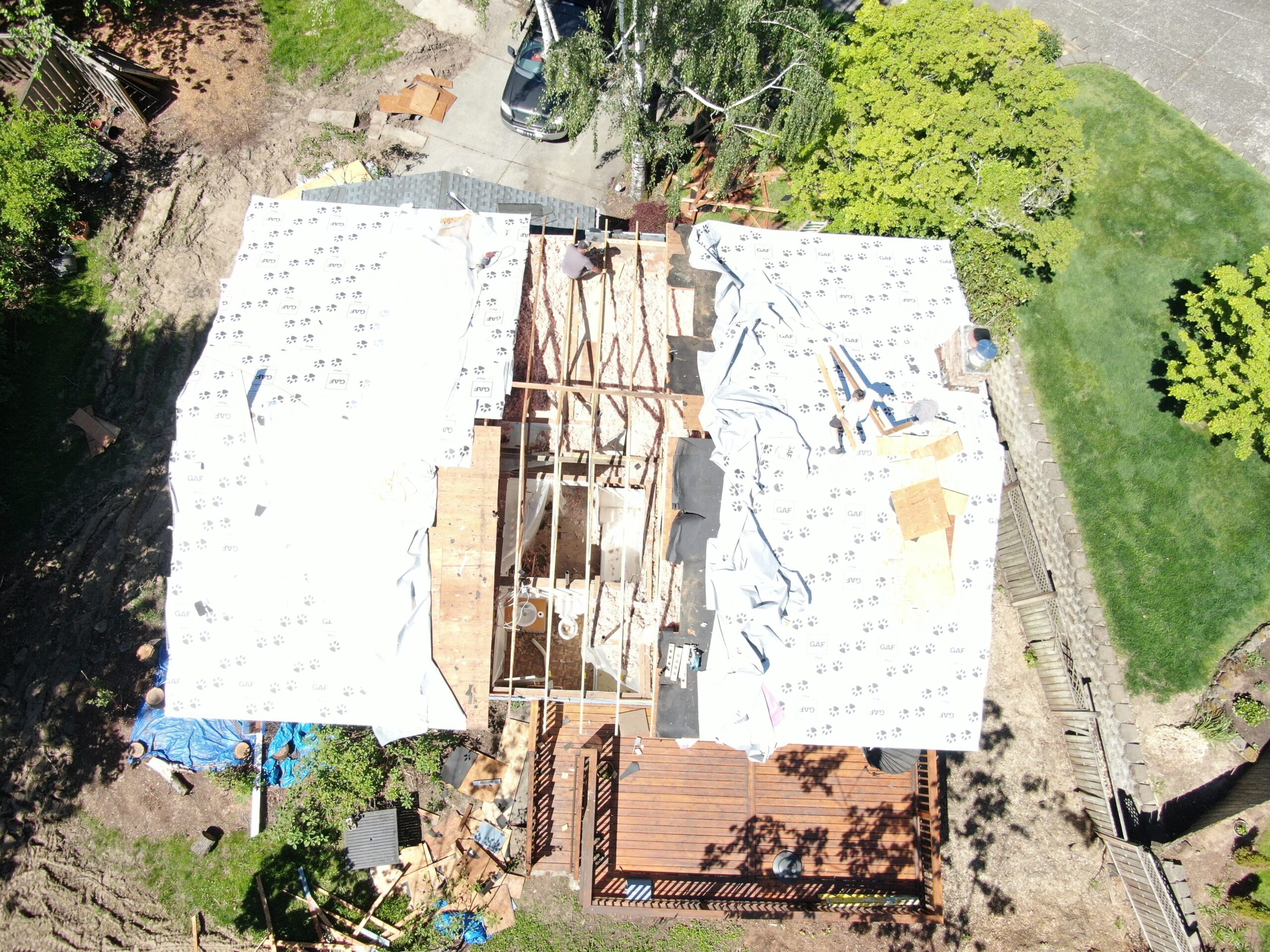 Aerial view of the Gresham roof opened for engineered truss replacement after tree impact
