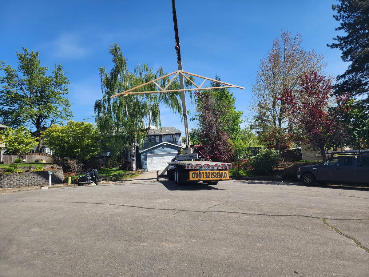 Precision Truss crane lifting a replacement engineered roof truss for the Gresham storm-damage repair